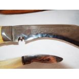 A Kuri knife complete with two smaller knives and leather sheath,