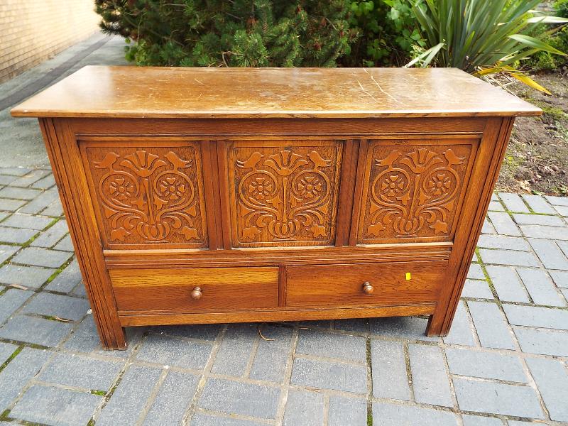 An oak linen chest with twin drawers below,