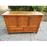 An oak linen chest with twin drawers below,