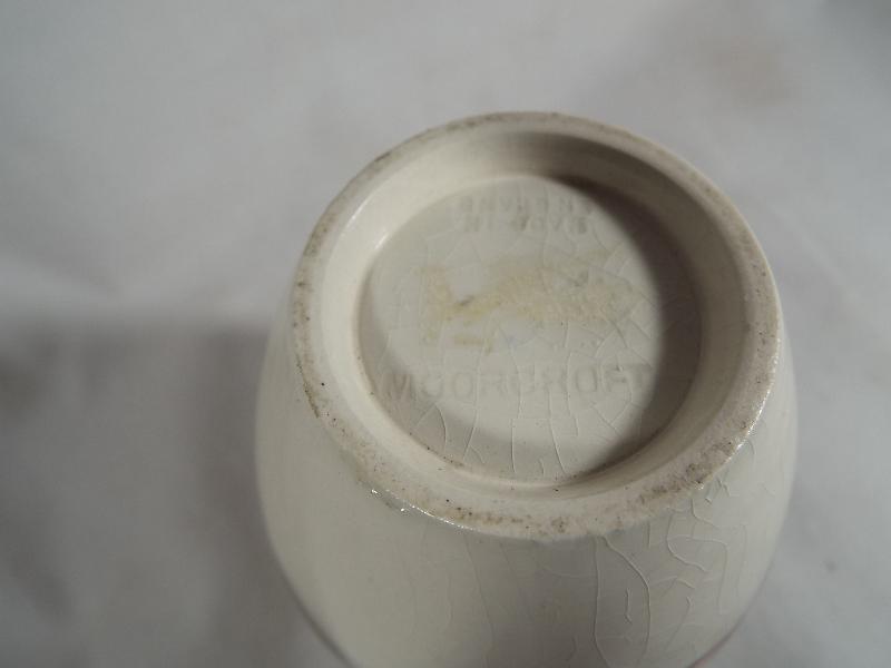 A Moorcroft pottery oviform vase with a floral pattern on a cream ground 11. - Image 3 of 3