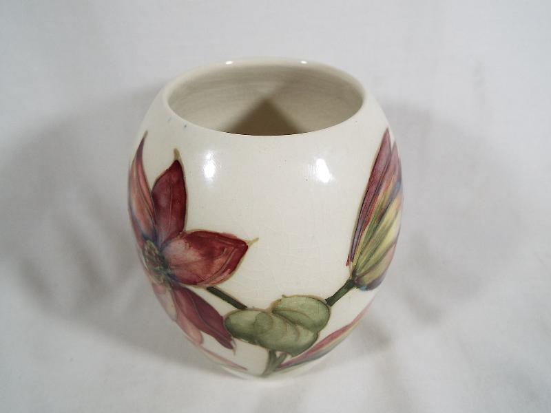 A Moorcroft pottery oviform vase with a floral pattern on a cream ground 11. - Image 2 of 3
