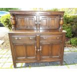 A mahogany court cabinet, two drawer with one fitted and lined partition drawer over two cupboards,