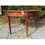 An oak half moon occasional table with tapered legs,