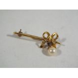 A lady's yellow metal bar brooch in the form of a bow (stamped,