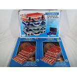 Two Linder coin tray boxes and a Leuchtturm case with coin trays,