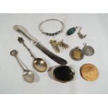 A mixed lot to include silver hallmarked tea spoons, white metal medallions, pendant, pill box,