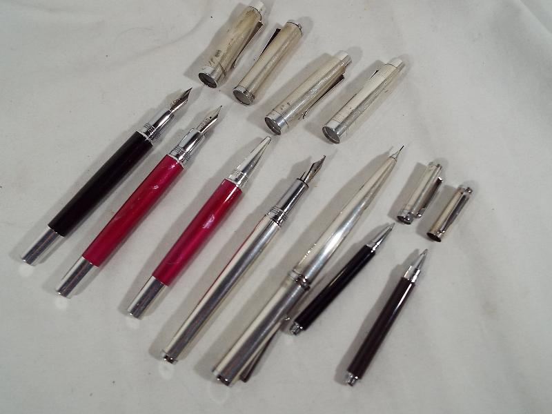 A collection of seven silver Lalex pens to include two miniature 1938, three fountain pens,