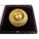 A lady's yellow metal, presumed 9ct gold, target brooch,