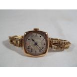 A lady's 9 carat gold cased, Art Deco styled wristwatch on a 9 carat gold expanding bracelet,