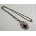 A lady's heavy silver necklace with unusual pendant,