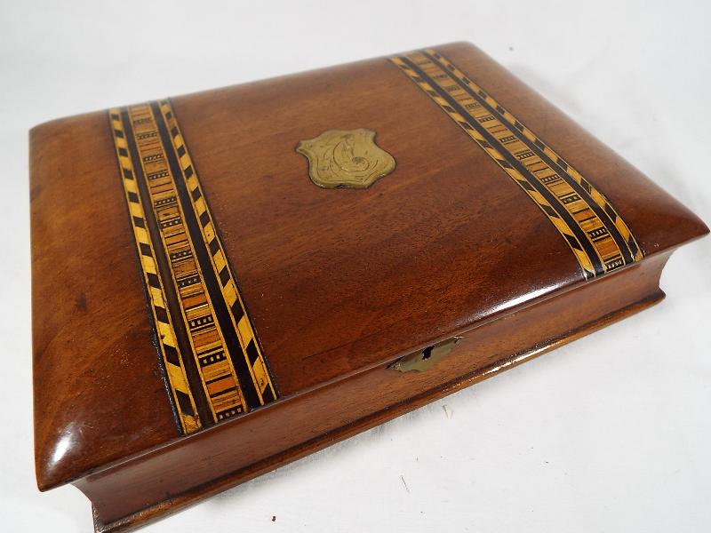 A mahogany stationery case with inlaid marquetry in the form of a book, fitted interior,