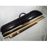 A good quality Donnay 18 ounce snooker cue entitled Dracula with a protective case and one other