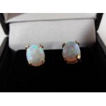 A pair of lady's 9ct gold earrings, set with opals,