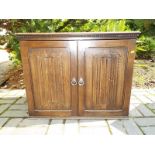 A JC oak two door cabinet,