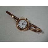 A lady's 9 carat rose gold cased wristwatch on a 9 carat rose gold expanding bracelet,