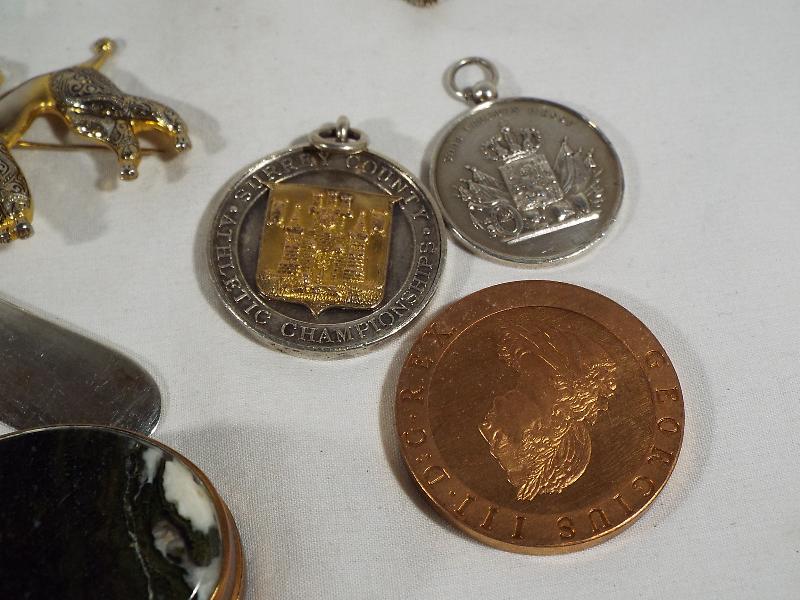 A mixed lot to include silver hallmarked tea spoons, white metal medallions, pendant, pill box, - Image 3 of 4