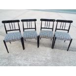 A good quality contemporary glass top extending dining table and four chairs with black and white