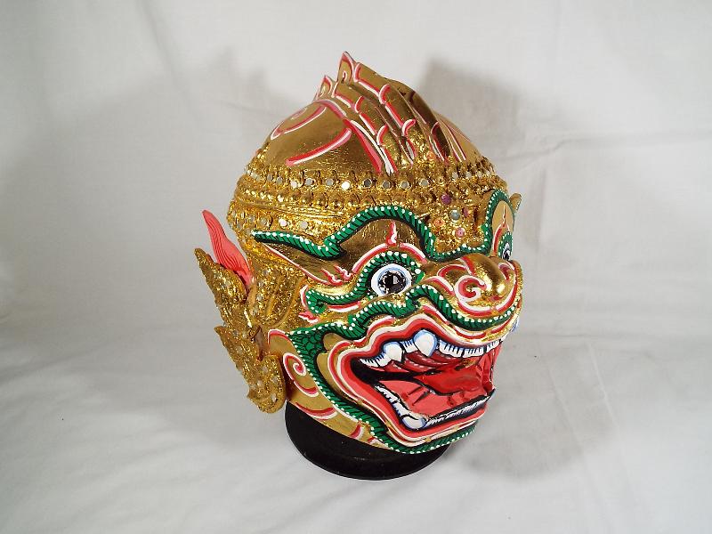 A Bolonese brightly coloured paper mache mask, on stand,
