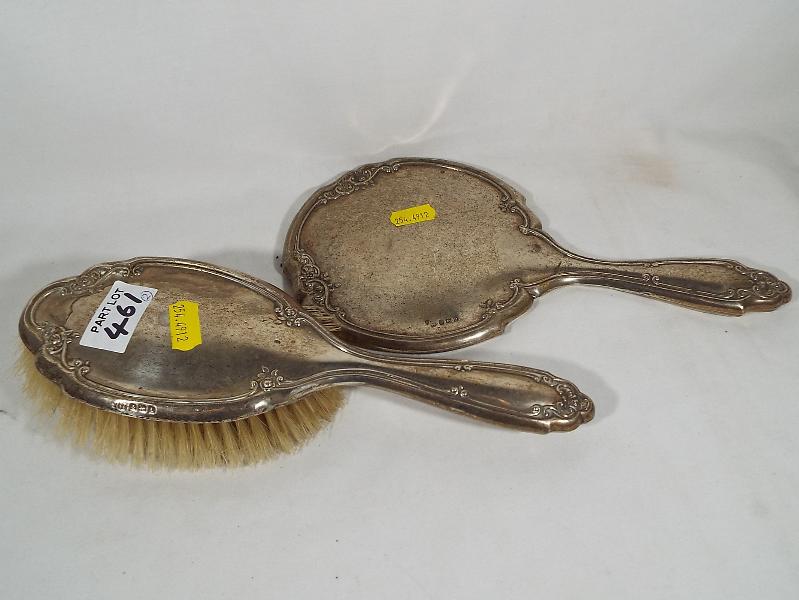 A George V silver hallmarked dressing table mirror and brush,