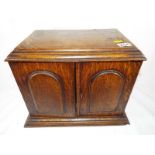 An smoker's oak cased cabinet with presentation plaque dated 1928,