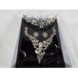 A multi-stone necklace, tiara and matching pair of earrings, unused,