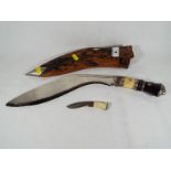 A Kuri knife compete with leather sheath,