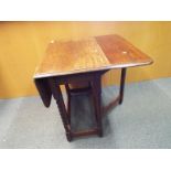 An oak gate leg drop leaf table on barley twist supports,