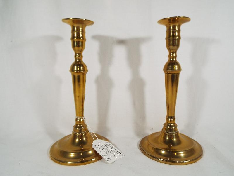 A pair of early 19th century bell metal candlesticks, ca George III period, 21.