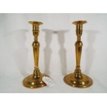 A pair of early 19th century bell metal candlesticks, ca George III period, 21.