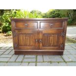 A JC carved oak cabinet, two drawer over door,