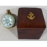 A good quality mahogany cased brass inlaid box containing a bulls eye clock depicting a ship,