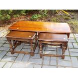 An Ercol coffee table with nesting occasional tables,