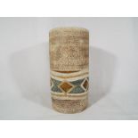 A Troika large cylindrical vase decorated in shades of beige and green, 18.7cm (h) x 9.