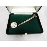 A silver golf tee, stamped 925,
