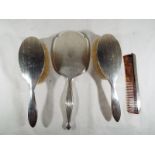A matched silver hallmarked dressing table set comprising two brushes, Birmingham assay 1926,