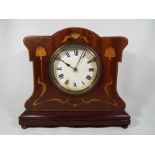 A mahogany and inlaid Art Nouveau style mantel clock,