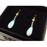 A lady's pair of 9ct gold drop earrings set with opal,