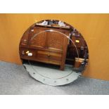 A bevel edged wall mirror, the outer rim with convex domes,