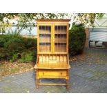 A light oak good quality bureau bookcase with a drop down writing desk with pigeon hole interior