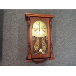 A contemporary dark wood cased wall clock with brass dial, Roman numerals signed Maxim,