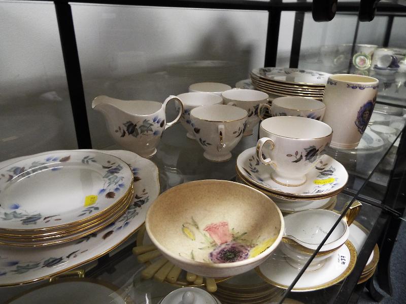 A quantity of 33 pieces of ceramic tableware by Colclough decorated with a floral pattern,
