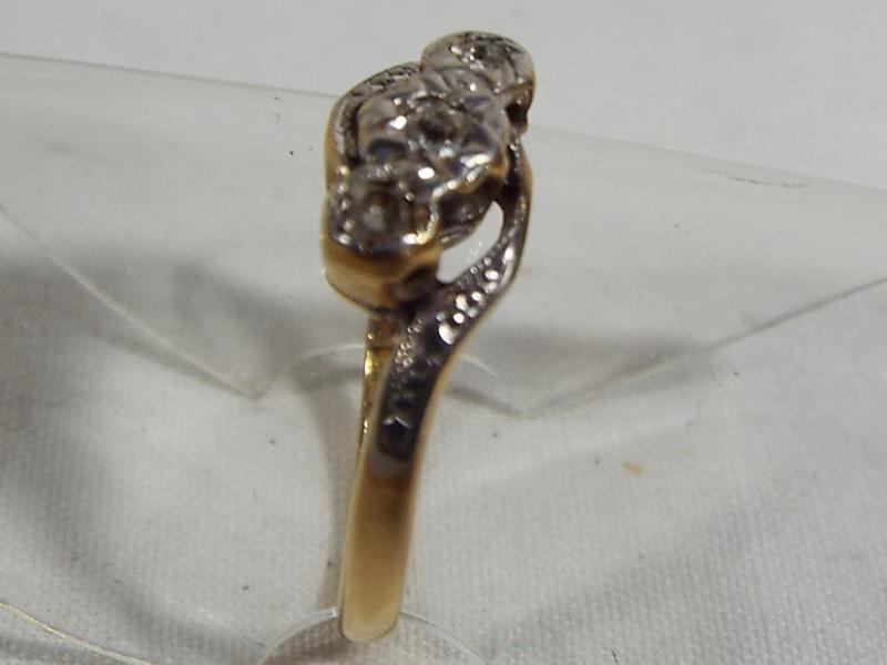 An 18ct gold and platinum three stone diamond cross over ring, set with old cut diamonds, size I1/2, - Image 2 of 2