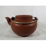 A large Chinese Yixing terracotta teapot with inner tea infuser c.