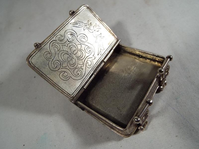 A silver vesta in the form of a miniature book with twin-internal compartments .800 - Image 5 of 5