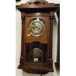 An early 20th century wall clock, Arabic numerals on a brass dial,