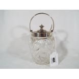 An Edward VII silver cut glass preserve pot with hallmarked silver rim, swing handle and cover,
