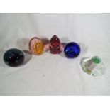 A collection of five glass paperweights to include Hartley Wood, Caithness, Wedgwood,