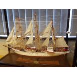 A scratch-built museum standard model of the clipper Sørlandet displayed in bow-fronted cabinet -