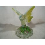 A hand painted Fenton glass ornament in the form of a butterfly signed to the base G.