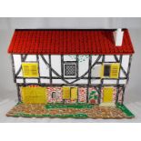 A vintage dolls house with removable roof together with associated dolls furniture